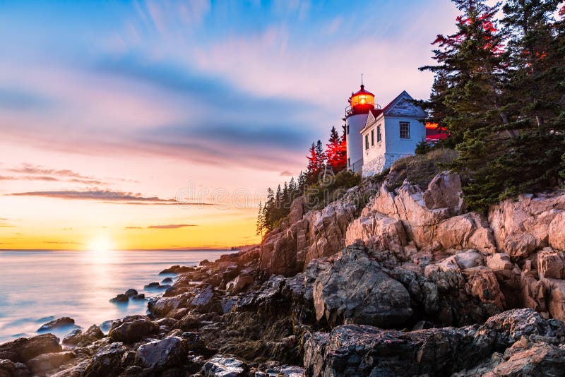 Bass Harbor Head lighthouse at sunset. Bass Harbor Head Light is a lighthouse located within Acadia National Park, Maine, marking the entrance to Bass Harbor and Blue Hill Bay. Bass Harbor Head lighthouse at sunset. Bass Harbor Head Light is a lighthouse located within Acadia National Park, Maine, marking the entrance to Bass Harbor and Blue Hill Bay